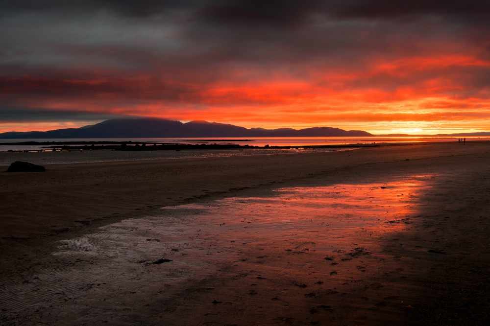 A dark red sunset on an Ayrshire beach.